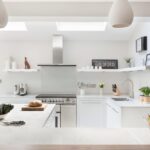 Bright Linear kitchen design featuring white kitchen cabinetry