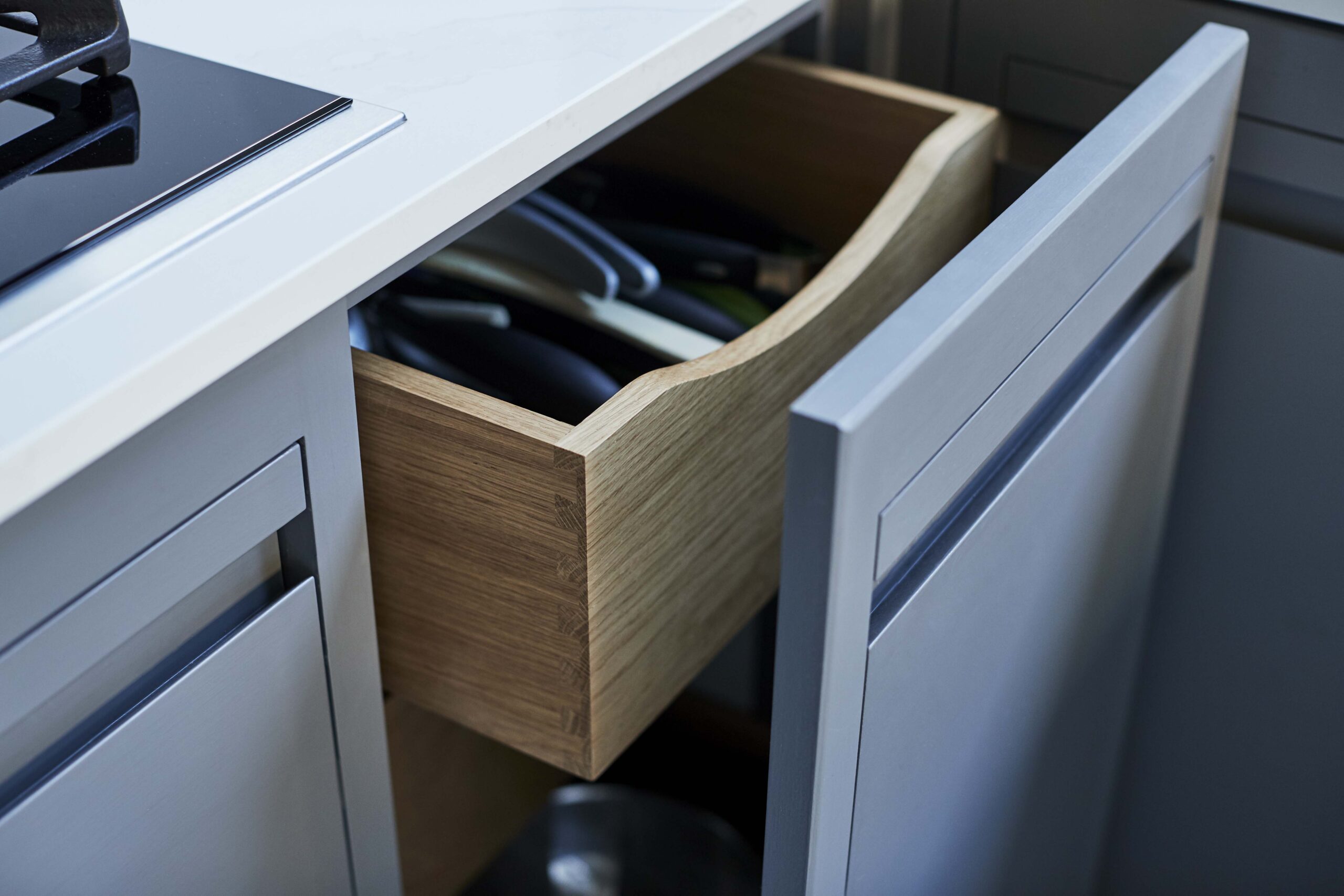 Grey Linear Edge kitchen drawer open to reveal oak storage