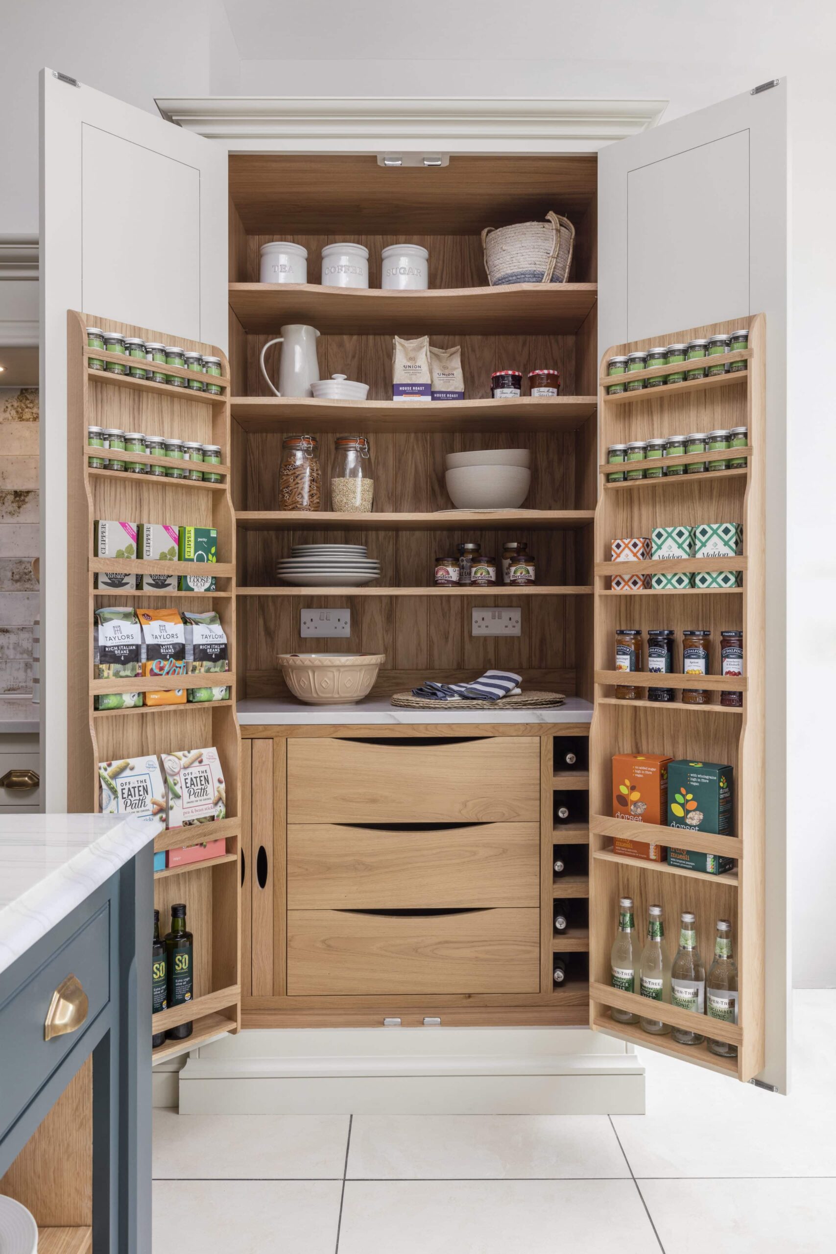 Open large pantry doors showing organised storage and drawers