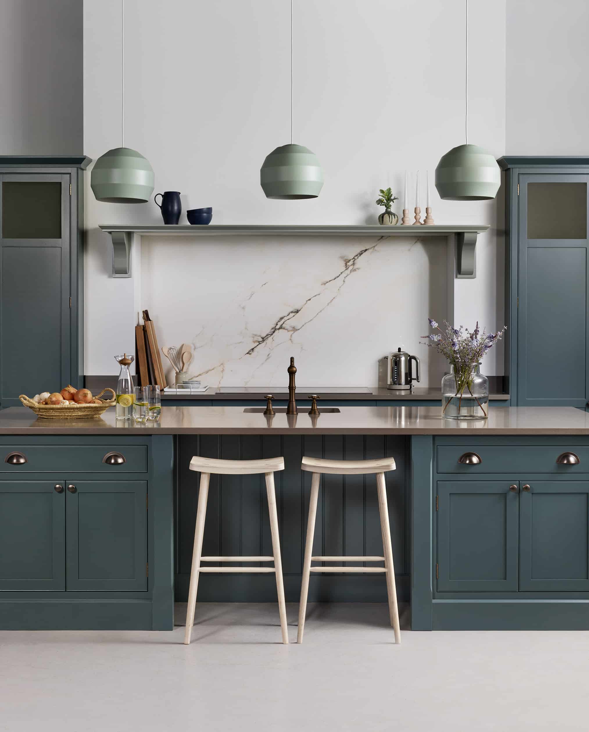 Nautural wooden smile stool against blue kitchen island