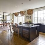 Black Shaker kitchen island overlooking open plan dining area