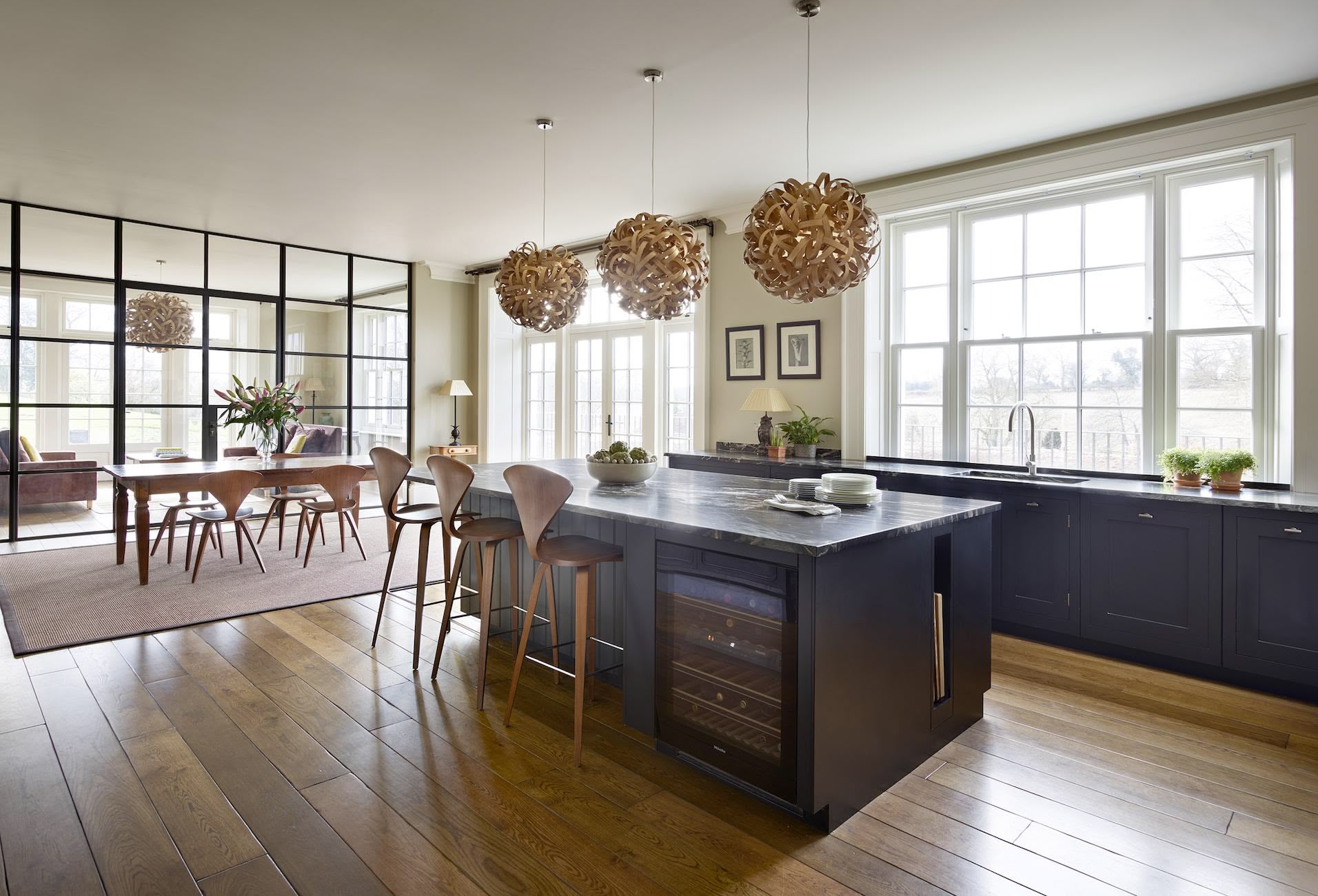 Black Shaker kitchen island overlooking open plan dining area