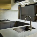 Grey Linear Edge kitchen island with white marble worktop featuring sink and integrated hob