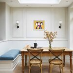 Dining area featuring off-white bench seating and blue cushioning