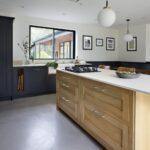 Light oak Shaker kitchen island with light grey worktop and integrated hob