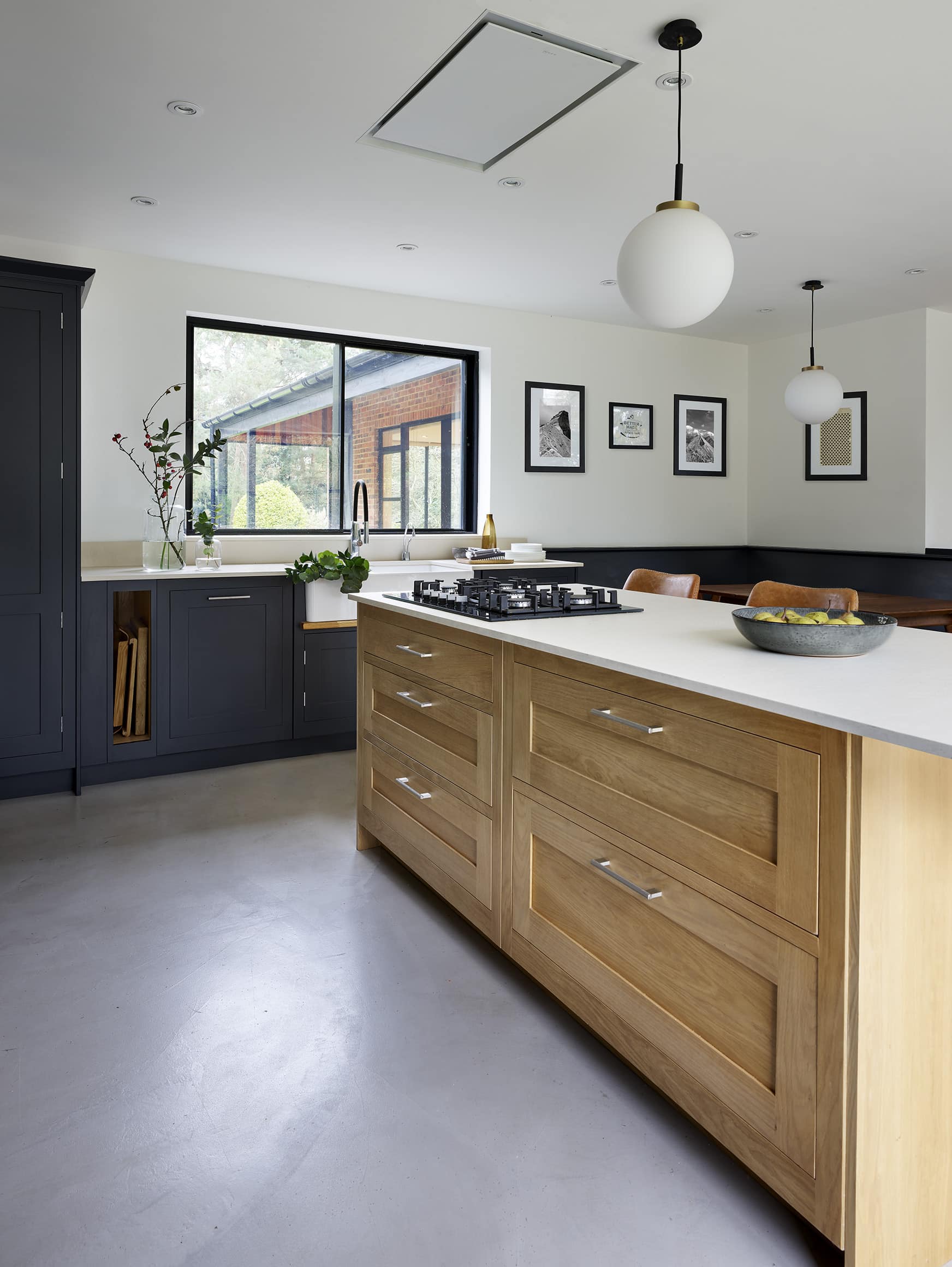 Light oak Shaker kitchen island with light grey worktop and integrated hob
