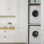 Utility room appliances shown within white cabinetry