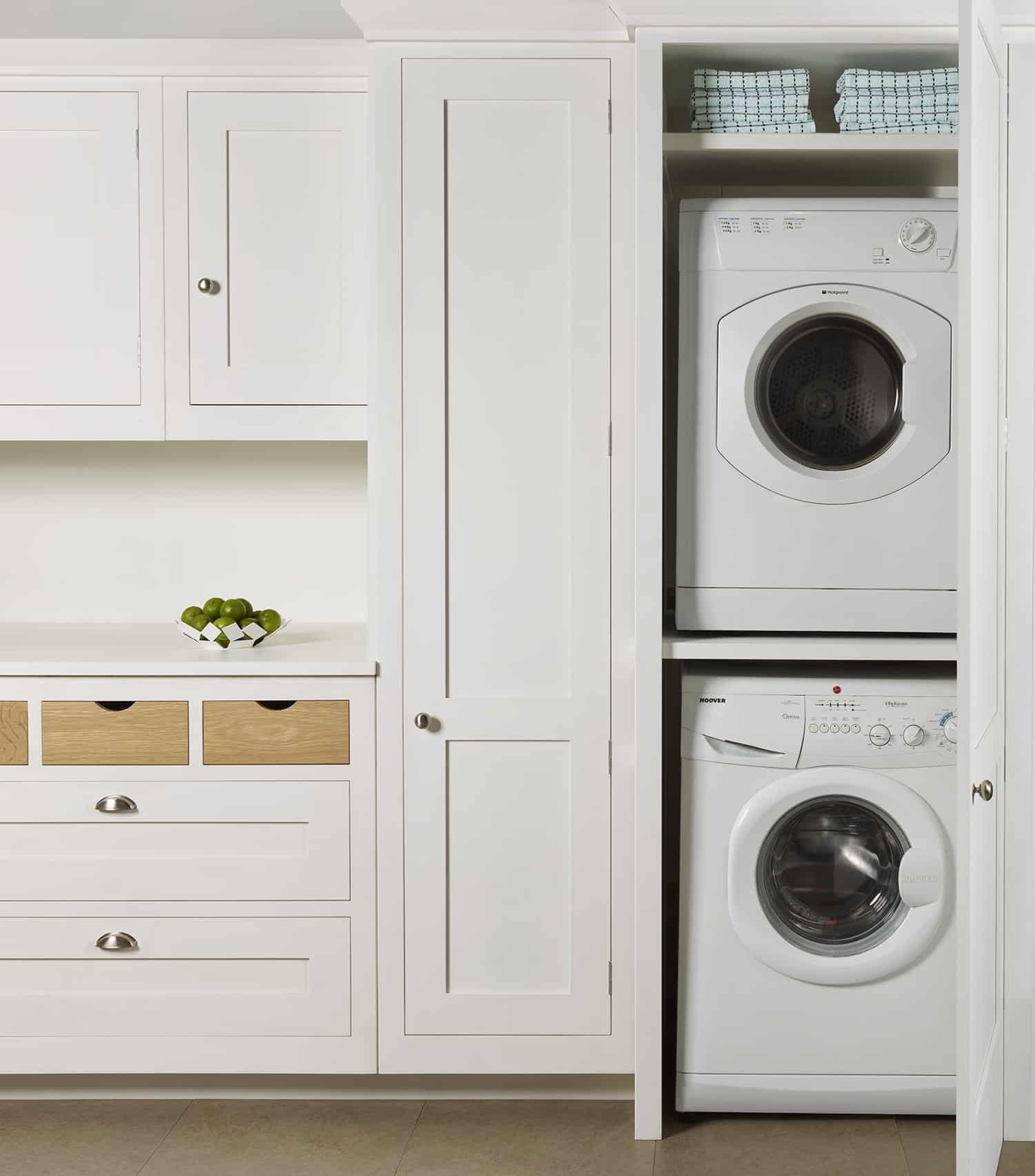 Utility room appliances shown within white cabinetry