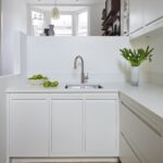 Whit Linear Edge kitchen cabinetry with white worktop and sink with silver tap