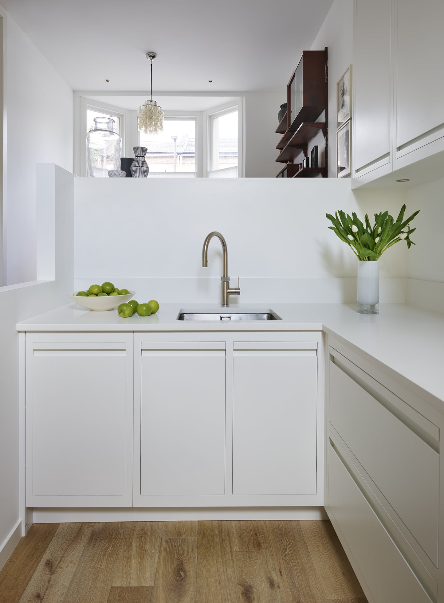 Whit Linear Edge kitchen cabinetry with white worktop and sink with silver tap