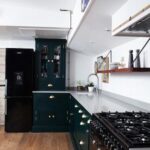 Walnut open shelving above white kitchen worktop