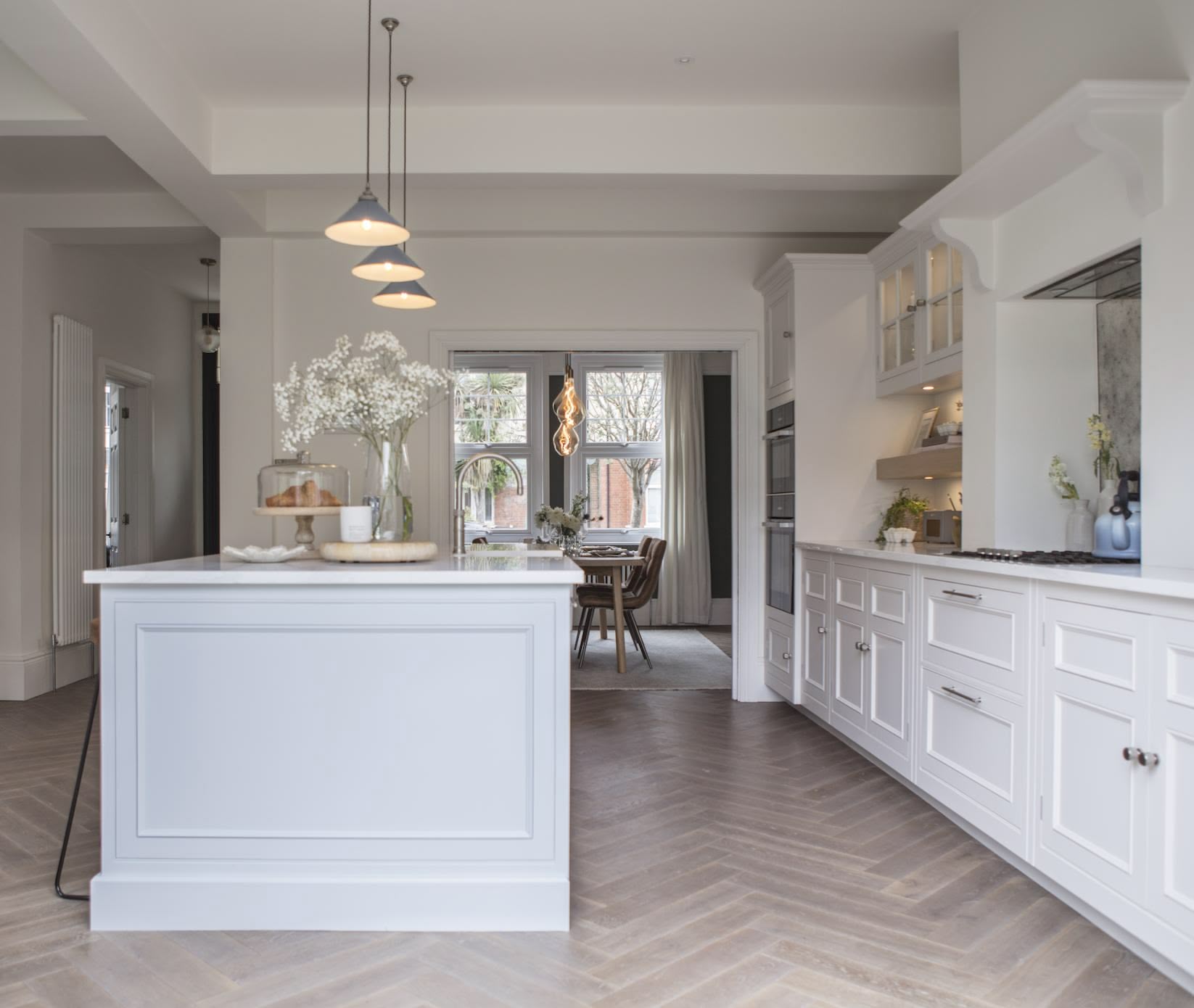 White Original design kitchen cabinetry with soft grey kitchen island with white worktops