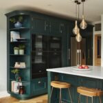 Vibrant green Original design kitchen cabinetry with integrated appliances and organised corner shelving