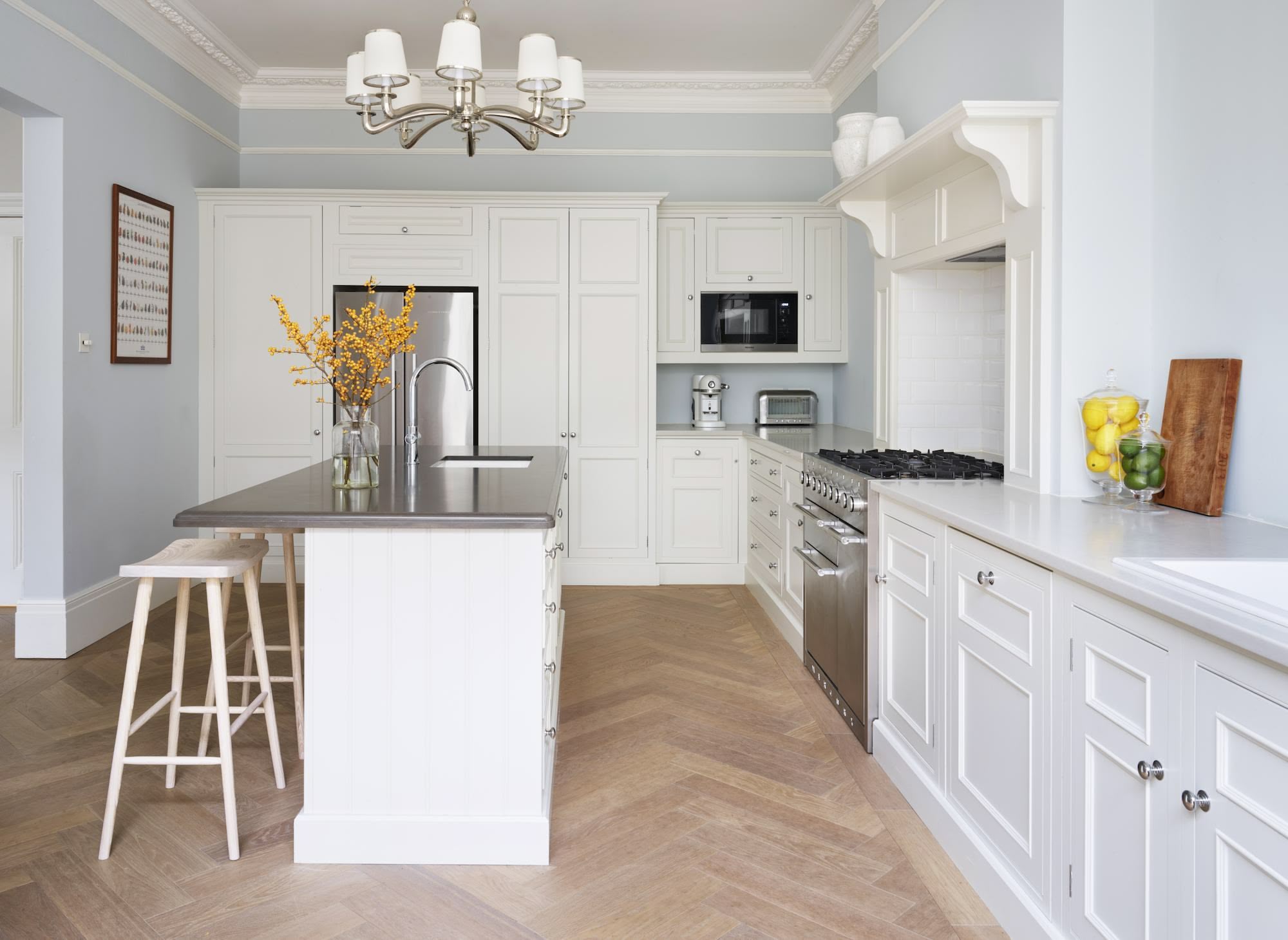 Off-white Original kitchen cabinetry against pale blue walls