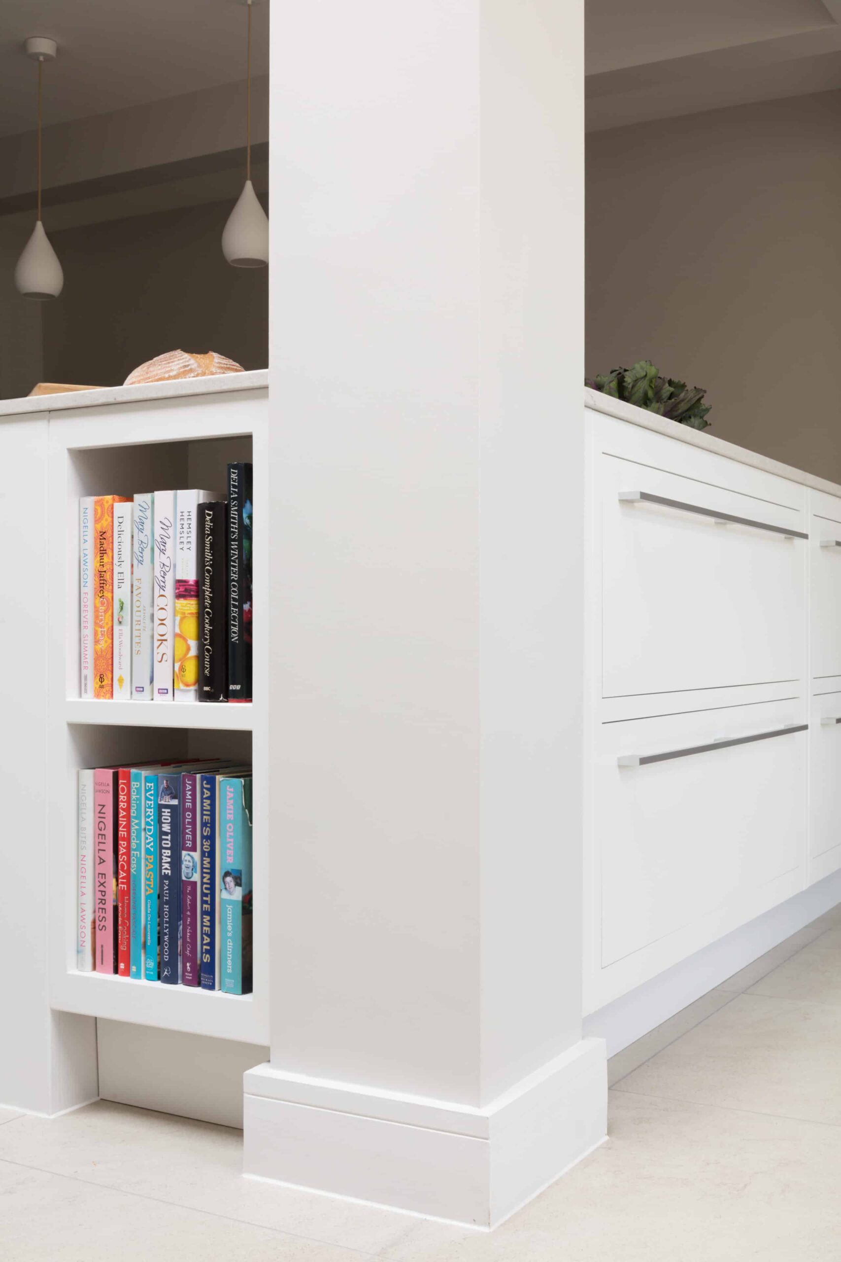White Linear kitchen island end panel featuring bookshelving