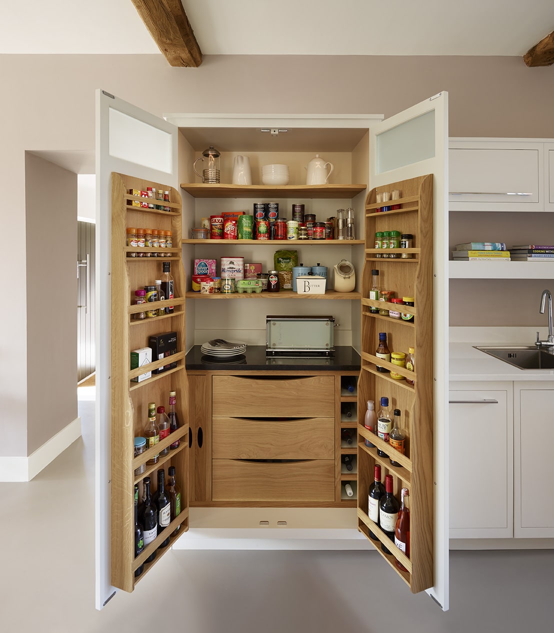 Open large pantry doors showing organised storage