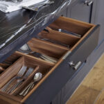 Black Shaker kitchen drawer open to show walnut interior