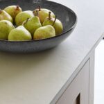 Light grey kitchen island worktop with dark Shaker kitchen cabinetry