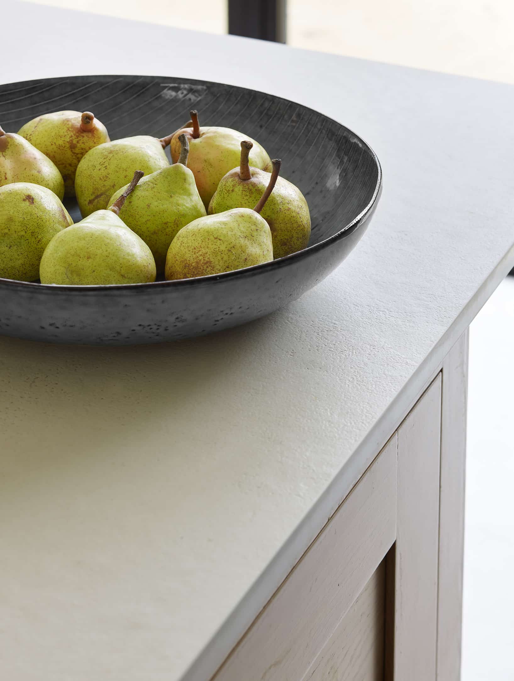Light grey kitchen island worktop with dark Shaker kitchen cabinetry
