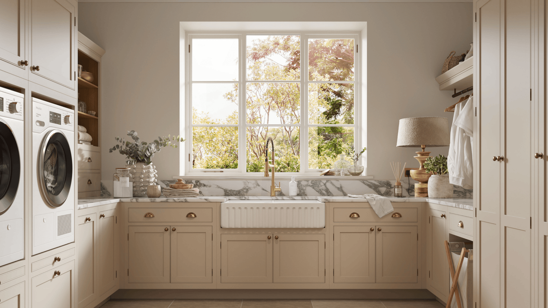 Beige utility room cabinetry featuring appliances and white basin sink