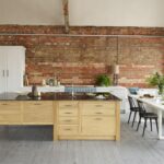 White Arbor kitchen cabinetry with an oak kitchen island with black worktop