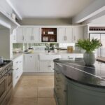 Arbor kitchen design with white kitchen cabinetry with white worktops and grey kitchen island with black marble worktop