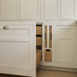 White integrated bin cupboard with light oak interior