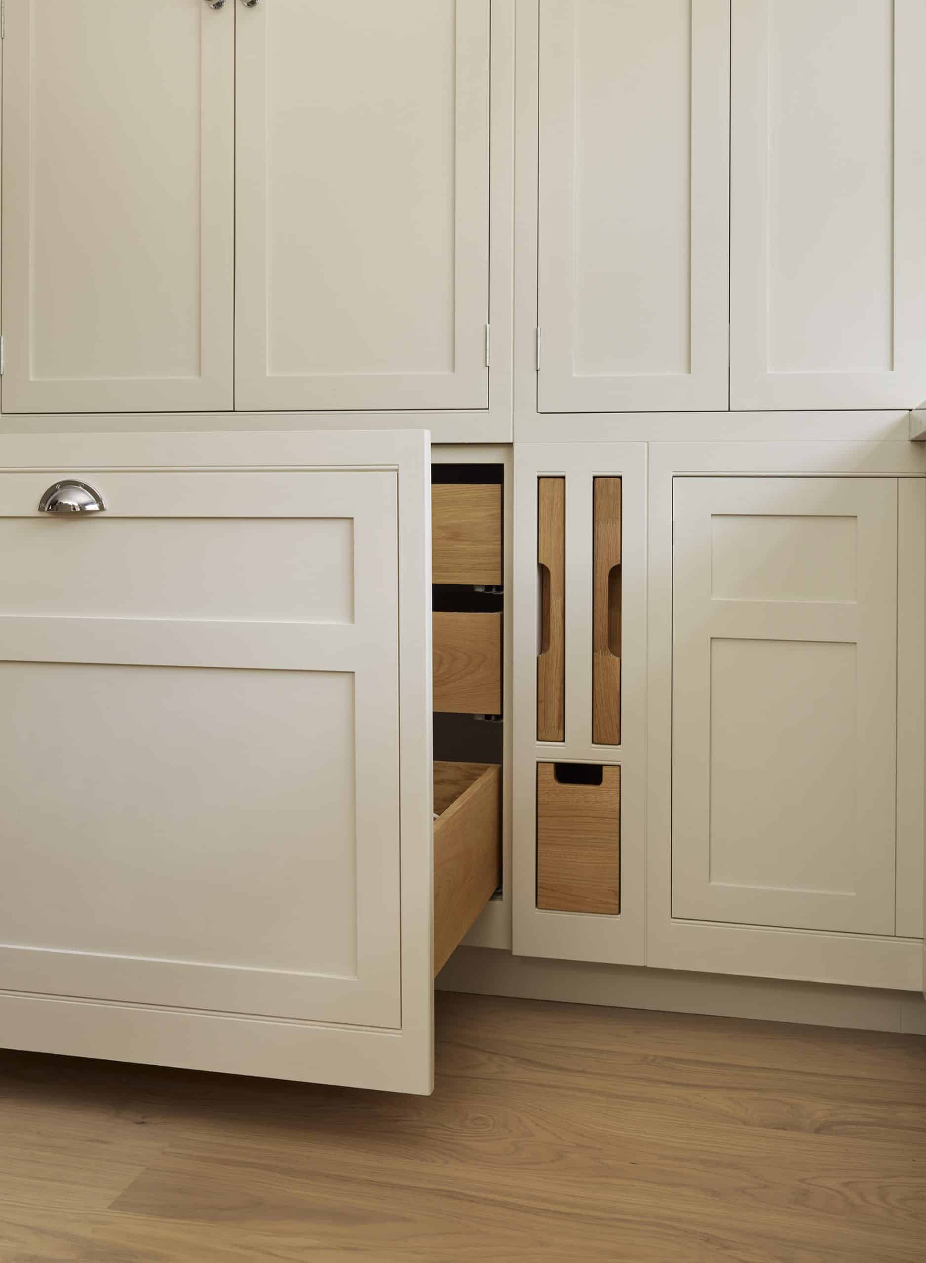 White integrated bin cupboard with light oak interior