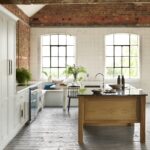 White Arbor kitchen cabinetry with an oak kitchen island with black worktop