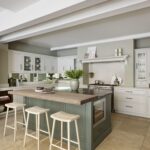 Grey Arbor kitchen island with black marble worktop and natural wooden extension featuring wooden stools
