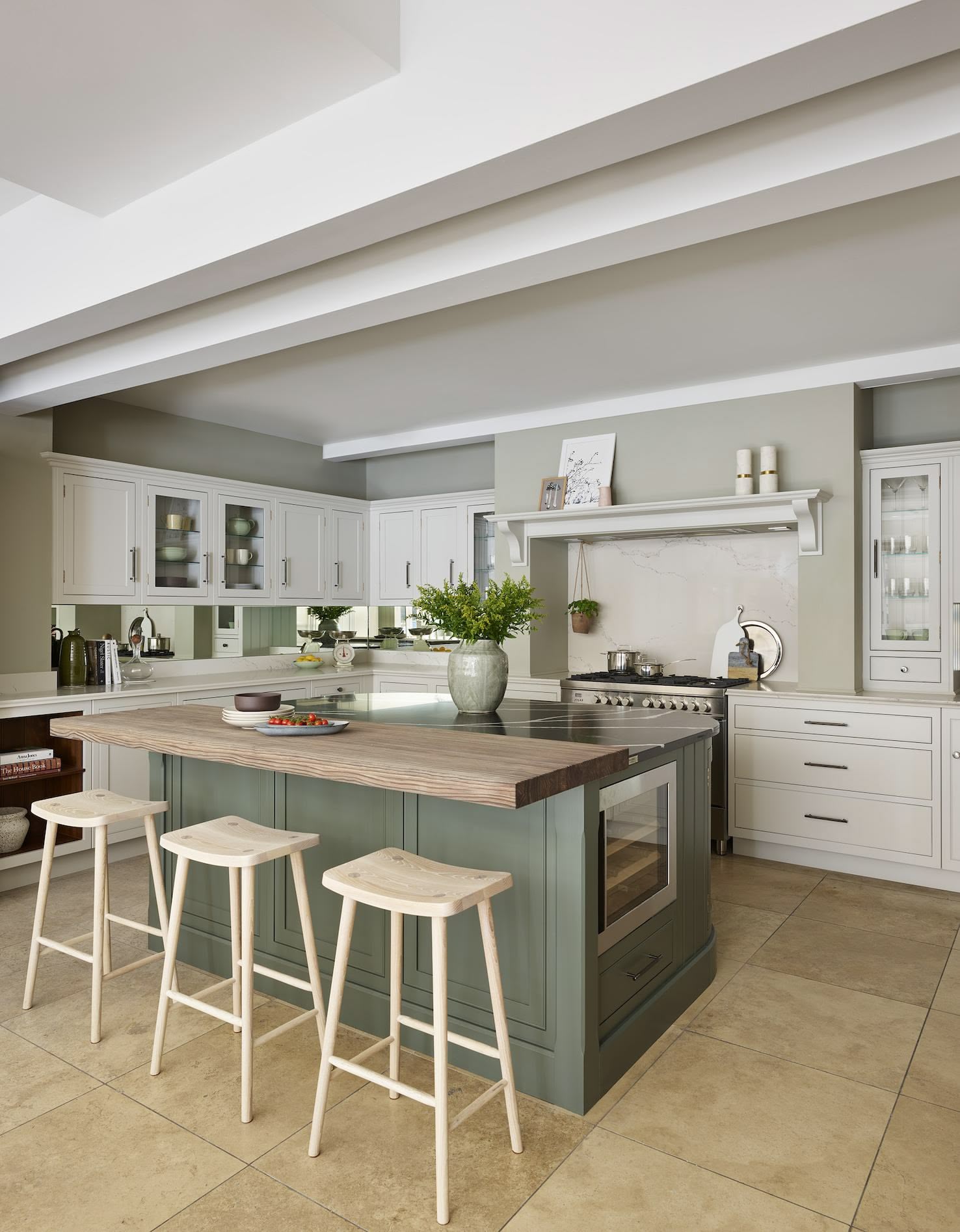 Grey Arbor kitchen island with black marble worktop and natural wooden extension featuring wooden stools