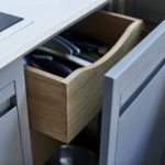 Grey integrated bin cupboard with light oak interior and drawer
