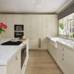 Tall beige kitchen cabinetry with integrated appliances