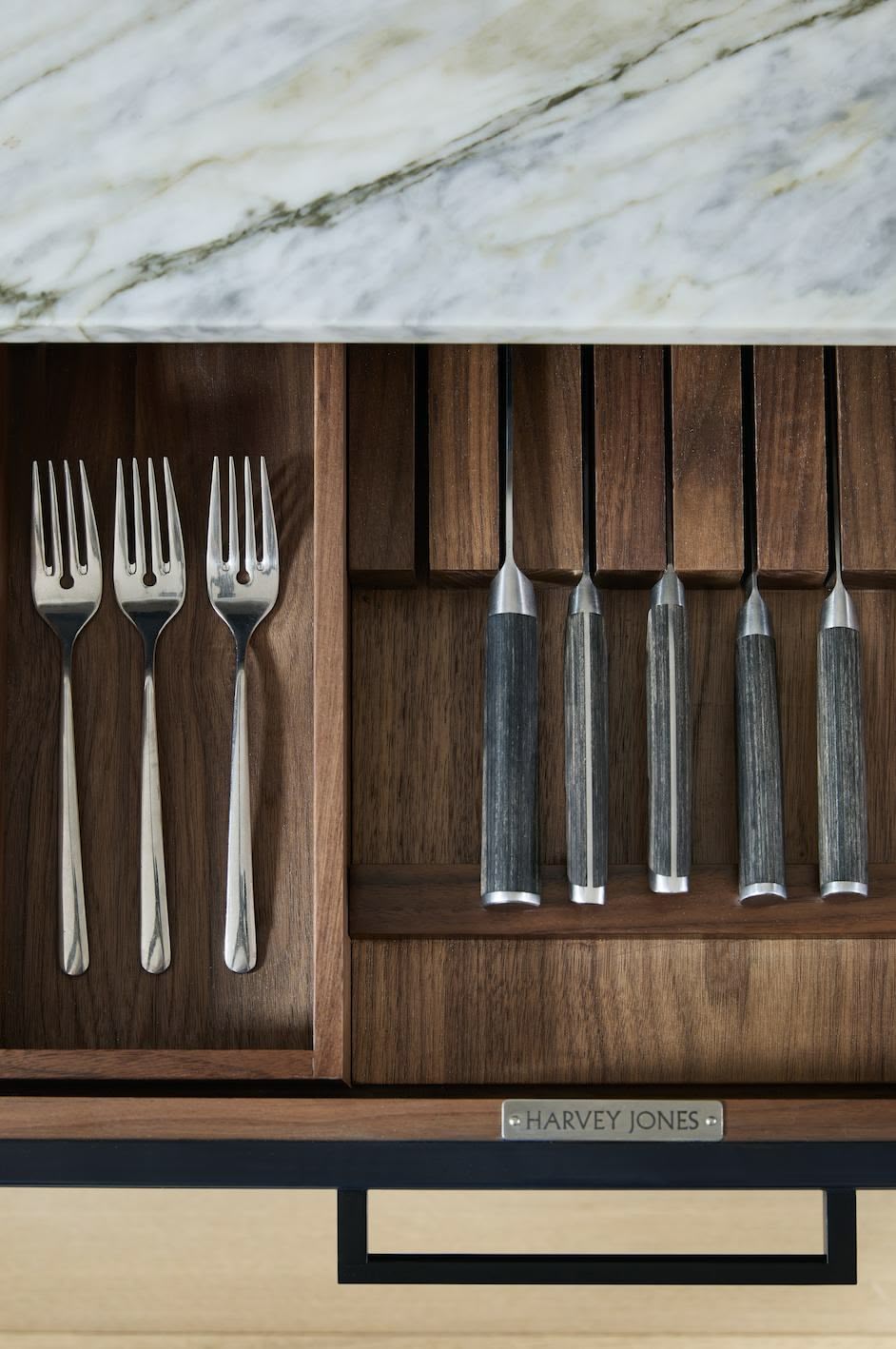 Black kitchen drawer with walnut interior open to show cutlery dividers