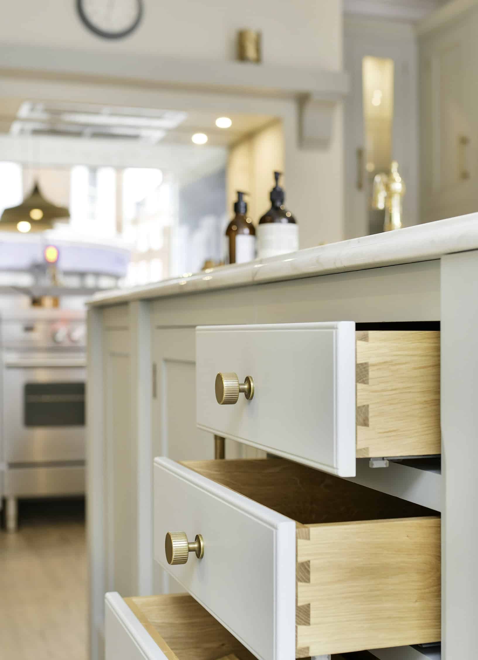 White kitchen drawers open to show oak interior