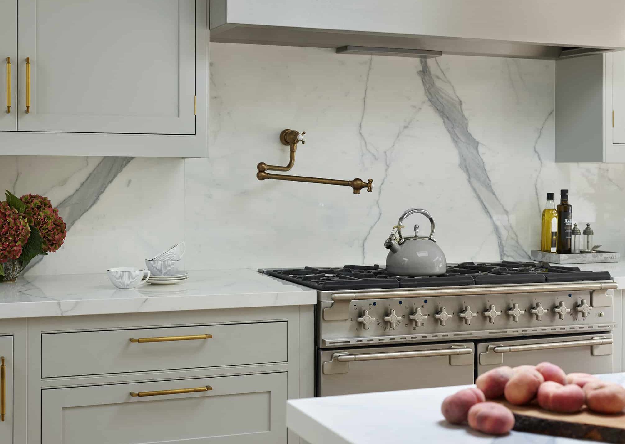 pot filler tap with white and grey marble splashback