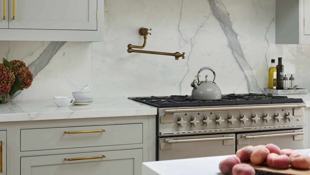 pot filler tap with white and grey marble splashback