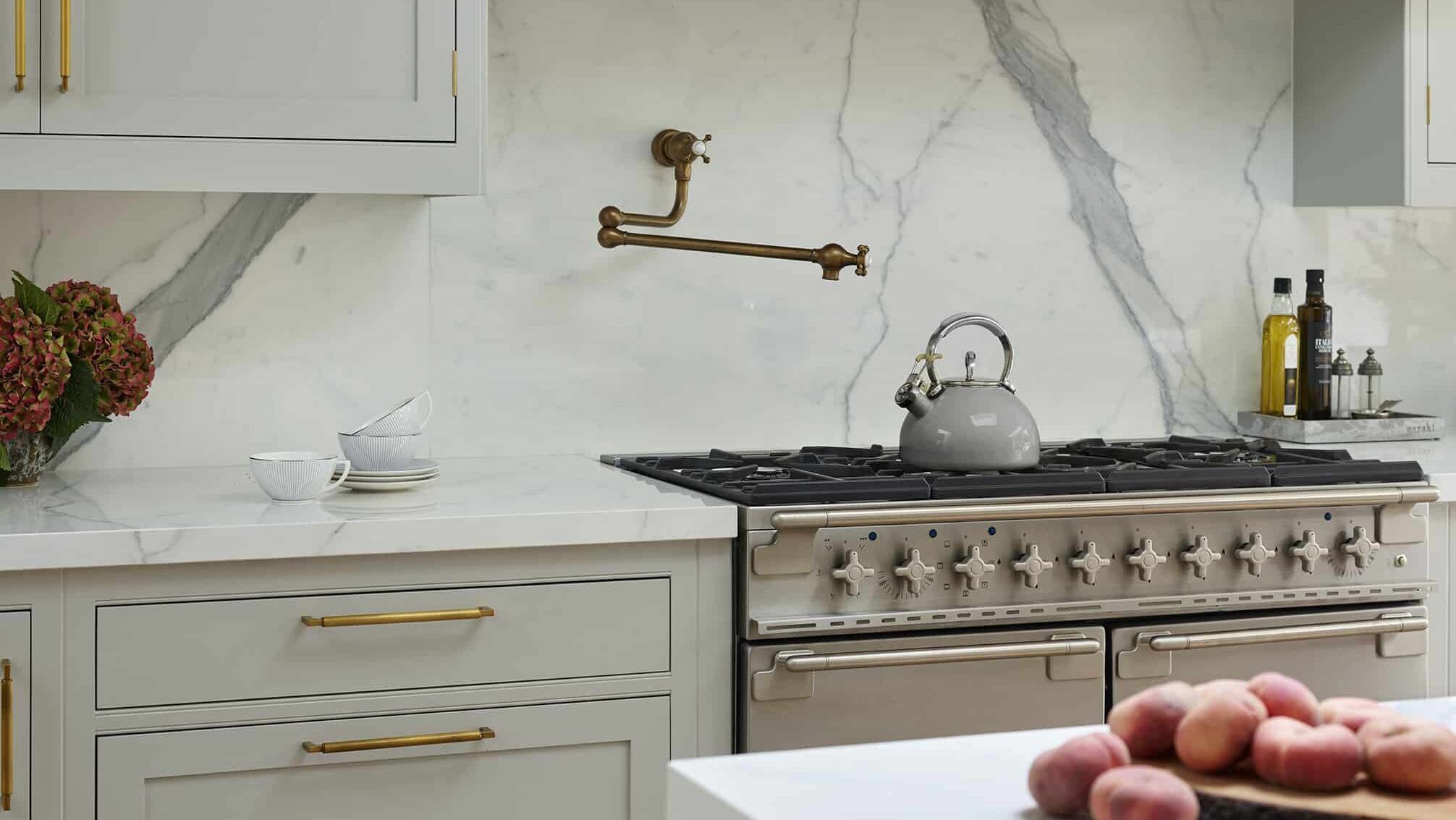 pot filler tap with white and grey marble splashback