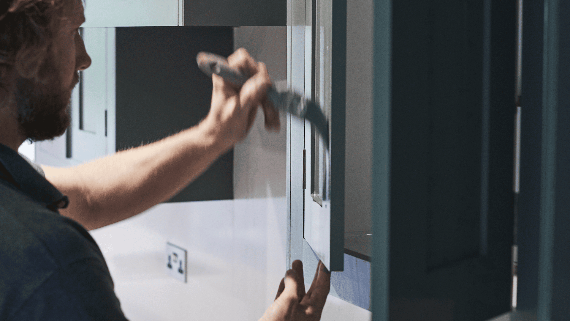 Handpainting of green kitchen cabinetry