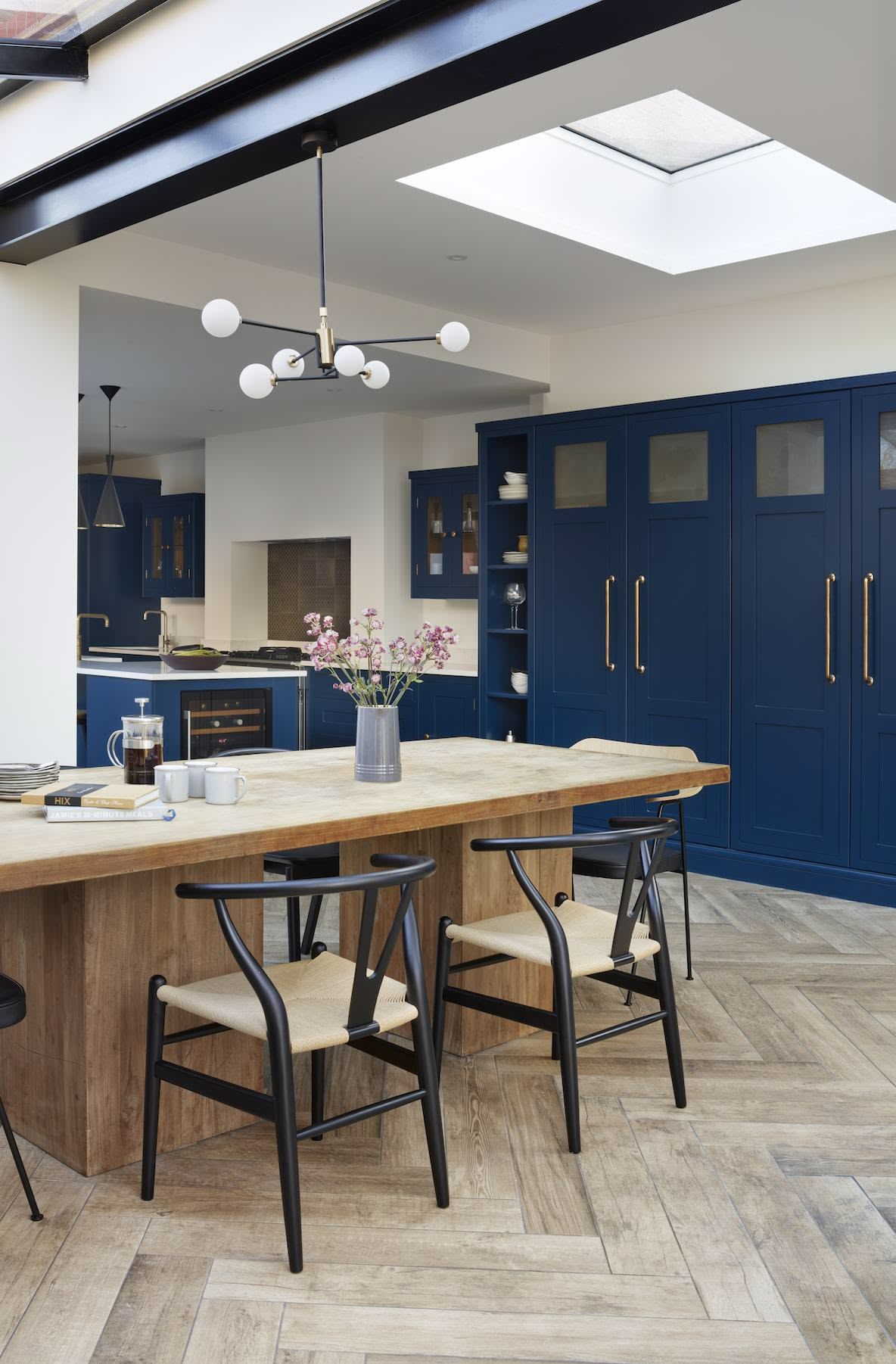 Blue kitchen cabinetry and open plan dining area