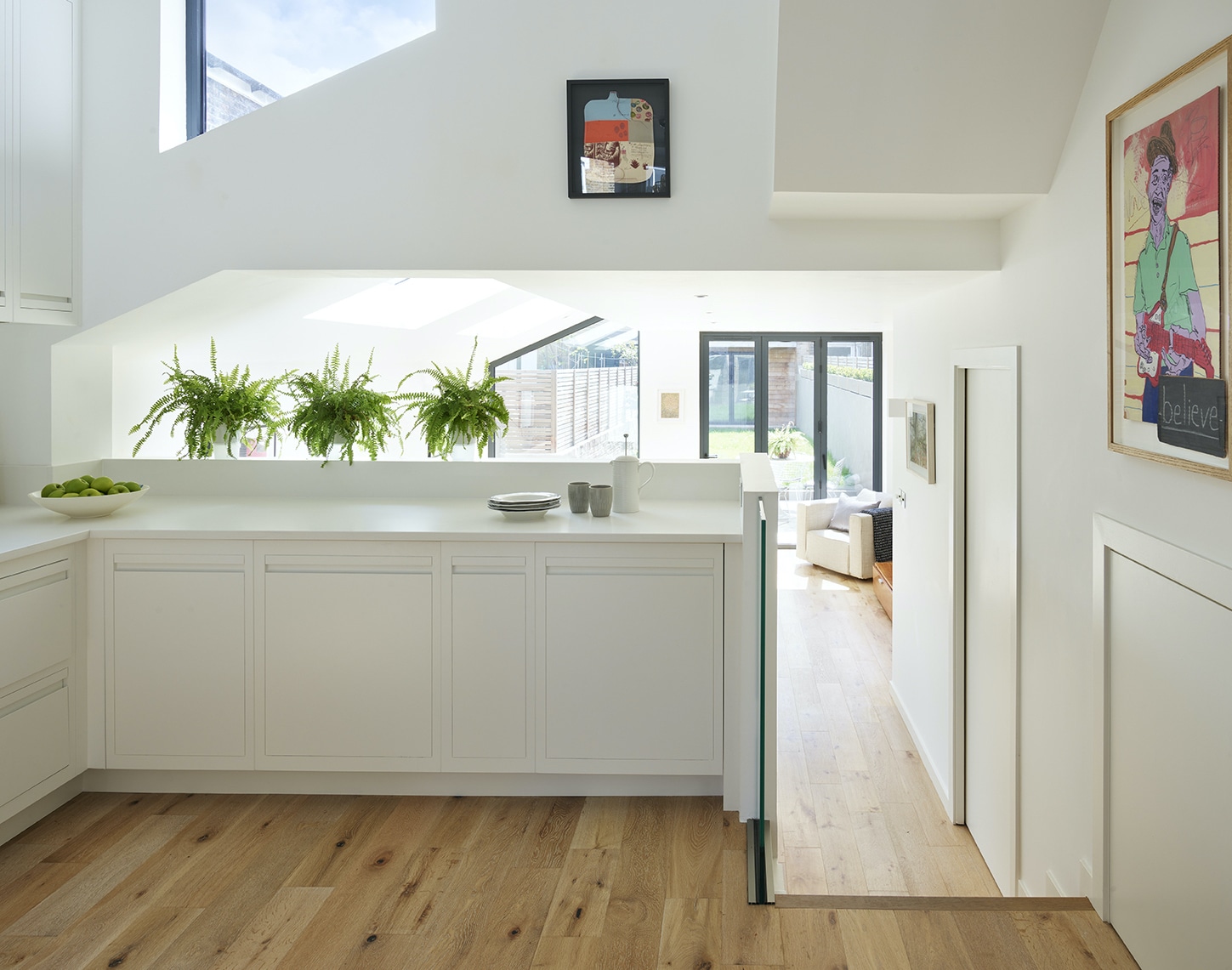 White Linear Edge handleless kitchen cabinetry with white worktops