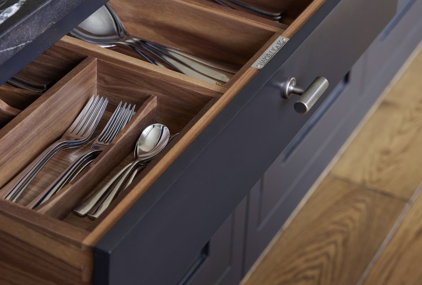 Black kitchen drawer open to show walnut cutlery dividers