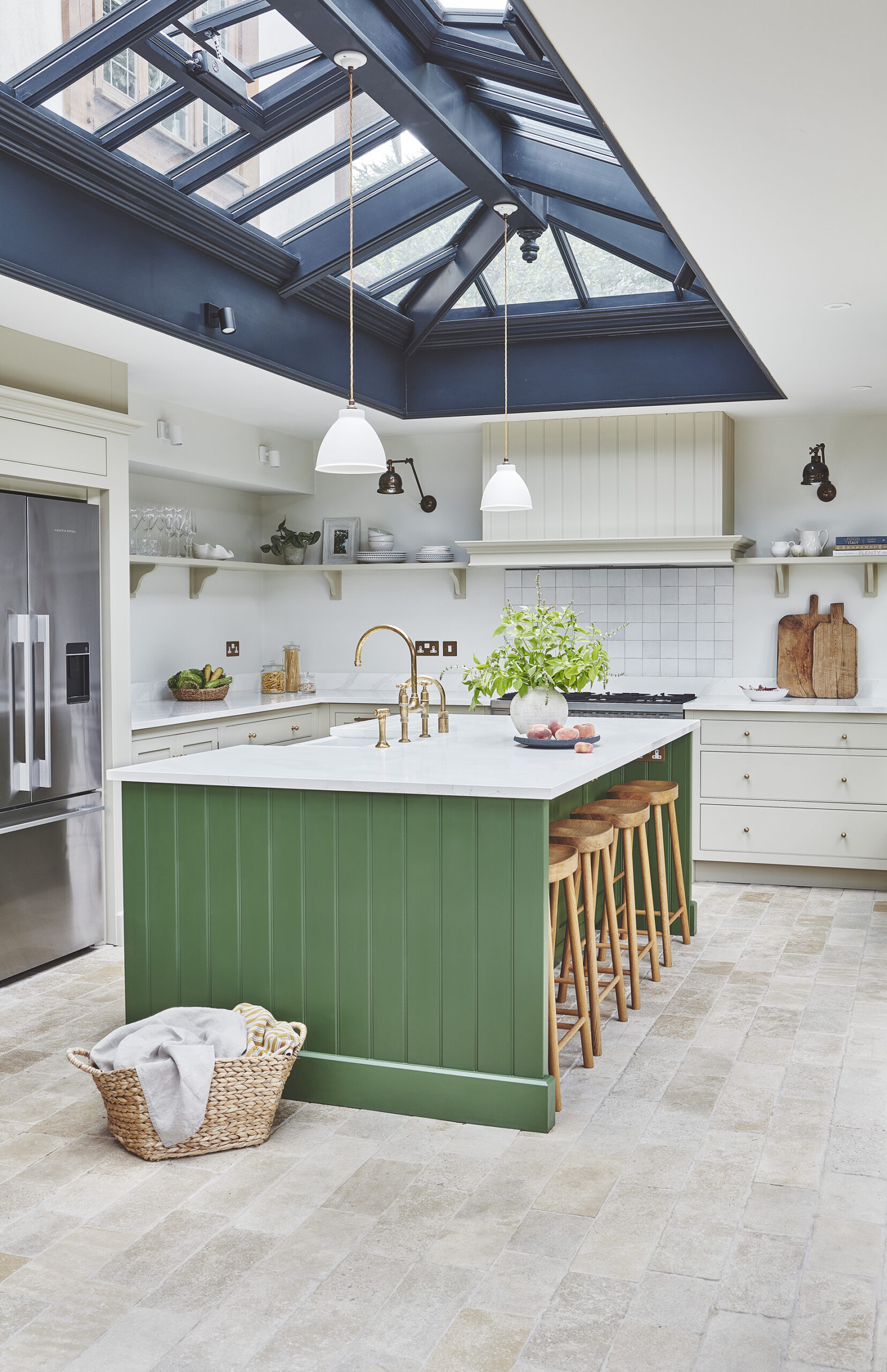Kitchen orangery featuring beige Arbor cabinetry and a green kitchen island with a white worktop