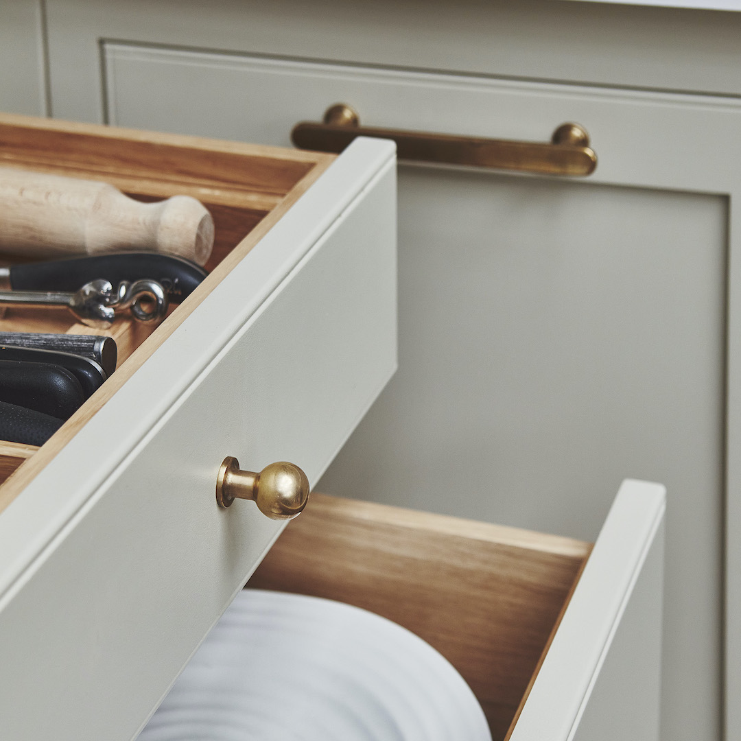Closeup of beige Arbor kitchen draws with brass handles
