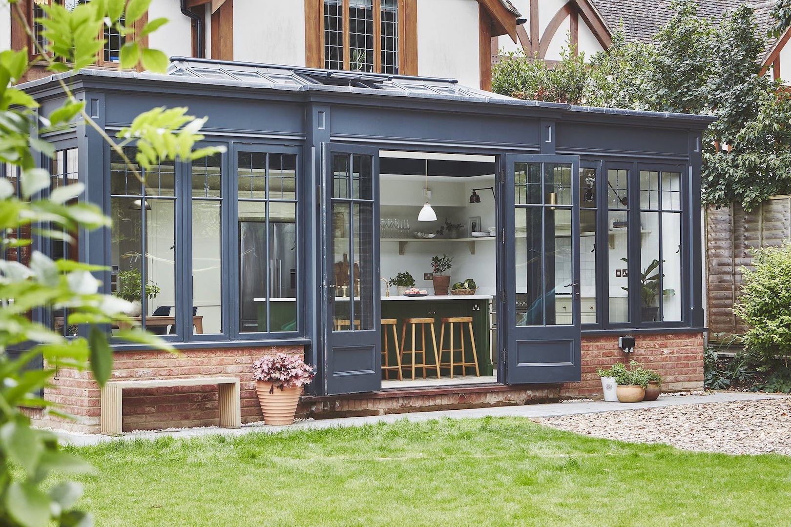 Outdoor garden view of an Arbor kitchen design within an orangery
