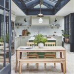 Kitchen orangery featuring a wooden dining area