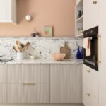 Harvey Jones and Swoon kitchen design featuring reeded cabinetry with marble worktop and splashback