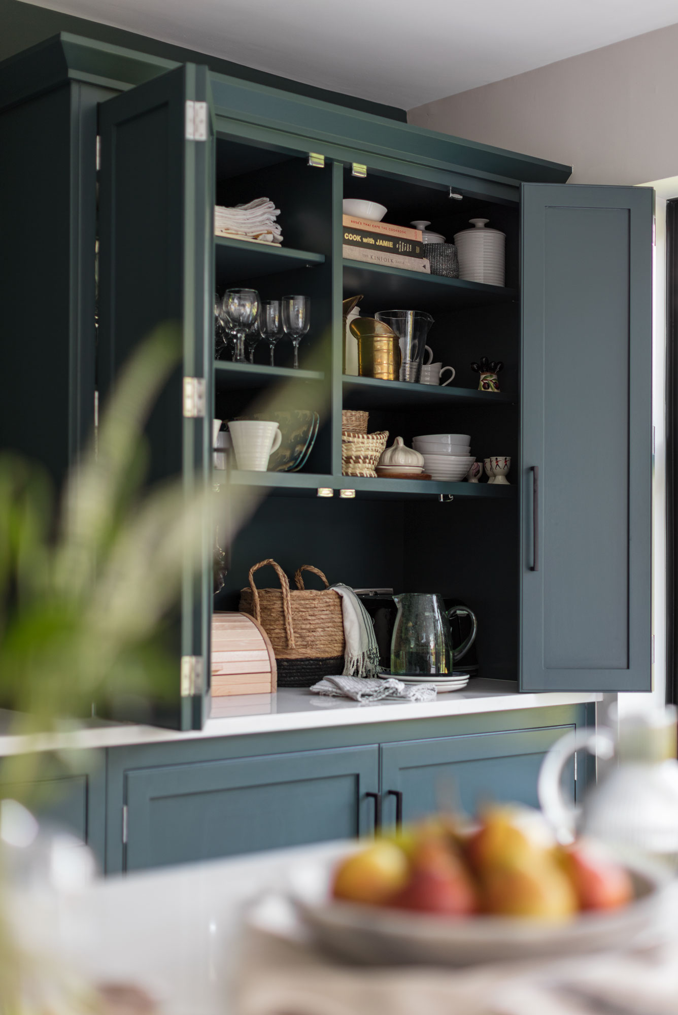 Teal Arbor kitchen cabinetry open revealing organised storage
