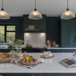 Teal Arbor kitchen design featuring kitchen island with white worktop