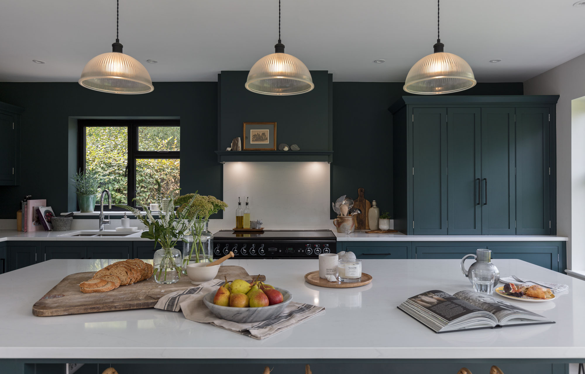 Teal Arbor kitchen design featuring kitchen island with white worktop